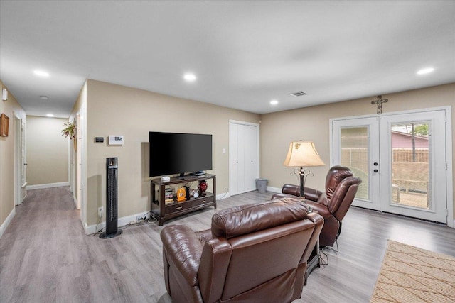 1410 Hummingbird Dr, Hillsboro, TX 76645 - living area with light wood finished floors, french doors, and recessed lighting