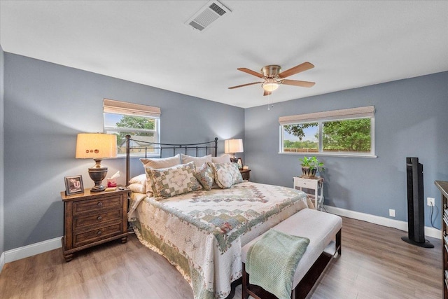 1410 Hummingbird Dr, Hillsboro, TX 76645 - bedroom featuring multiple windows, wood finished floors, and a ceiling fan