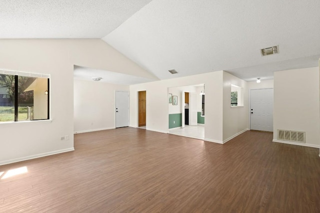 132 Spanish Oak Dr, Georgetown, TX 78628 - unfurnished living room with wood finished floors and lofted ceiling
