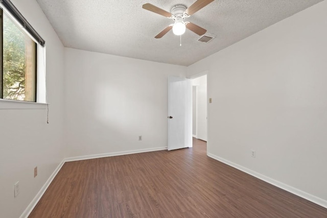 132 Spanish Oak Dr, Georgetown, TX 78628 - empty room featuring wood finished floors, a textured ceiling, and ceiling fan