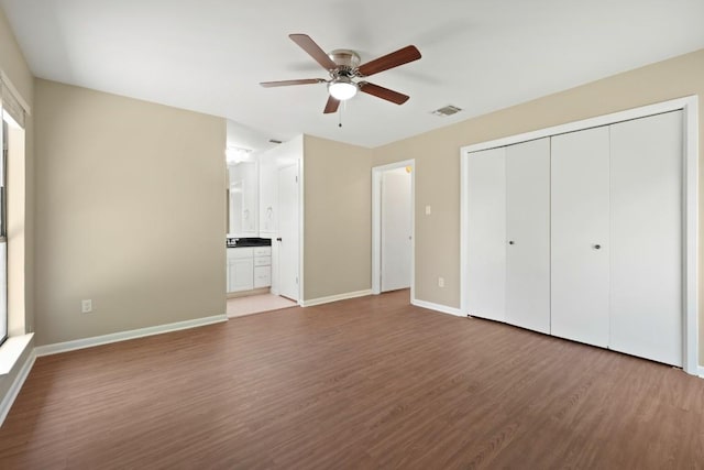 132 Spanish Oak Dr, Georgetown, TX 78628 - unfurnished bedroom featuring wood finished floors, a closet, ceiling fan, and ensuite bath