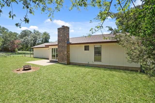 132 Spanish Oak Dr, Georgetown, TX 78628 - back of house featuring an outdoor fire pit, a chimney, and a patio area