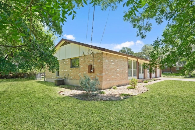 132 Spanish Oak Dr, Georgetown, TX 78628 - view of property exterior featuring brick siding, a lawn, a garage, board and batten siding, and driveway