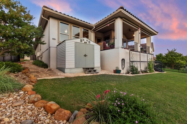 9110 Bayshore Bnd Unit 30, Austin, TX 78726 - back of property at dusk featuring a shed and a balcony