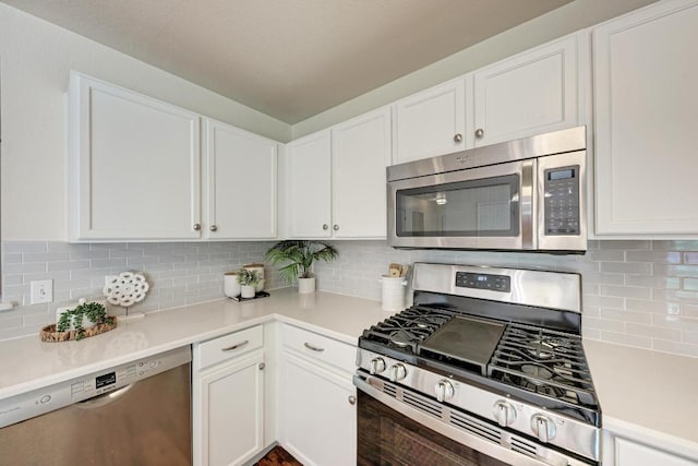 1803 Kwai Cv, Leander, TX 78641 - kitchen with stainless steel appliances, white cabinetry, light countertops, and decorative backsplash