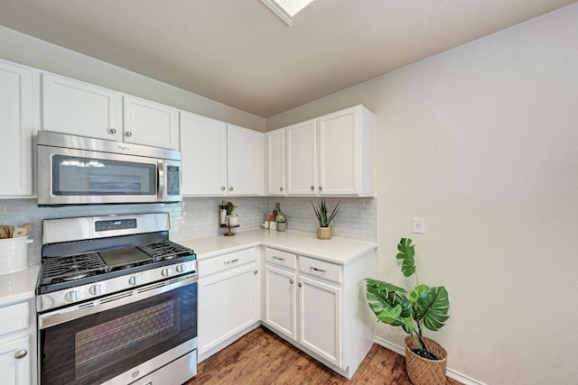 1803 Kwai Cv, Leander, TX 78641 - kitchen featuring appliances with stainless steel finishes, light wood finished floors, light countertops, and decorative backsplash