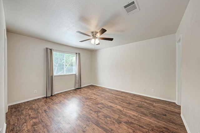 1803 Kwai Cv, Leander, TX 78641 - empty room with ceiling fan, dark wood finished floors, and a textured ceiling