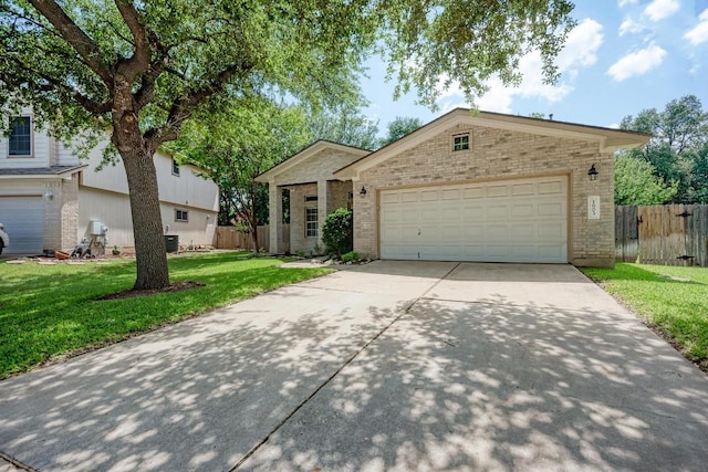 1803 Kwai Cv, Leander, TX 78641 - view of front of house featuring brick siding, concrete driveway, and an attached garage