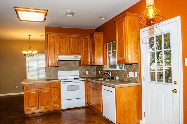 2003 White Dove Pass, Austin, TX 78734 - kitchen featuring white appliances, under cabinet range hood, and brown cabinets