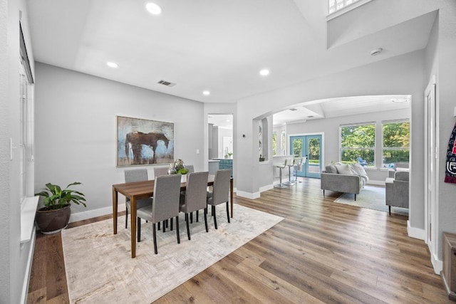 15001 Doria Dr, Austin, TX 78728 - dining space with arched walkways, recessed lighting, and wood finished floors