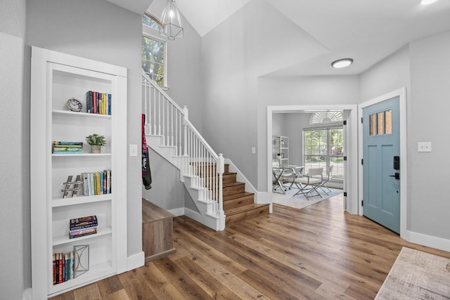 15001 Doria Dr, Austin, TX 78728 - foyer entrance with wood finished floors, stairs, and lofted ceiling