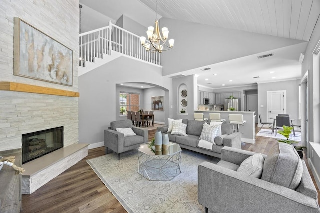 15001 Doria Dr, Austin, TX 78728 - living room featuring arched walkways, a chandelier, wood finished floors, high vaulted ceiling, and recessed lighting