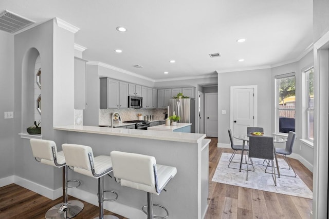 15001 Doria Dr, Austin, TX 78728 - kitchen with stainless steel appliances, gray cabinetry, light countertops, light wood-type flooring, and recessed lighting
