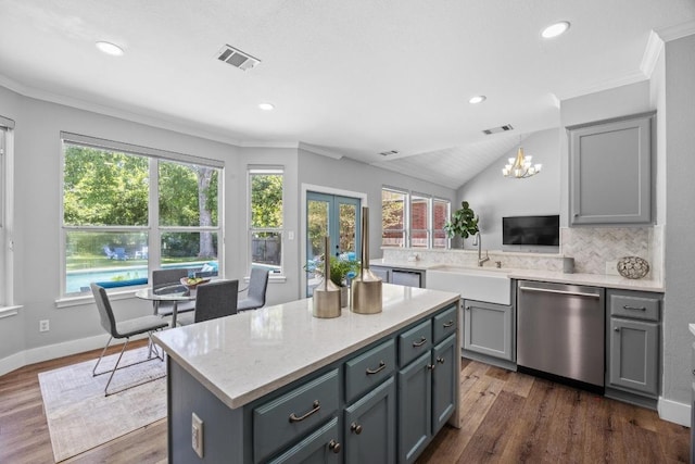 15001 Doria Dr, Austin, TX 78728 - kitchen with dishwasher, gray cabinetry, crown molding, a chandelier, and dark wood-style floors