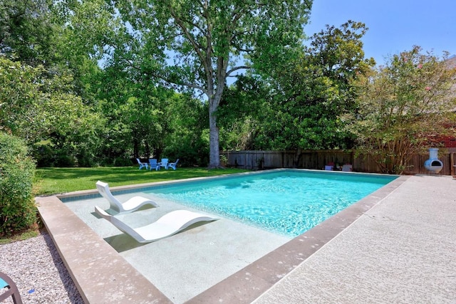 15001 Doria Dr, Austin, TX 78728 - view of swimming pool with a fenced backyard, a patio area, and view of wooded area