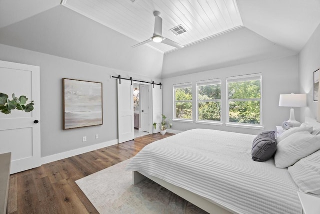 15001 Doria Dr, Austin, TX 78728 - bedroom featuring vaulted ceiling, a barn door, wood finished floors, and a ceiling fan