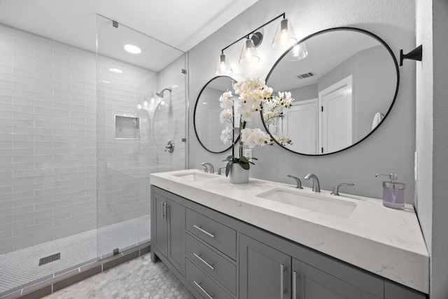 15001 Doria Dr, Austin, TX 78728 - full bath with double vanity, tiled shower, and recessed lighting