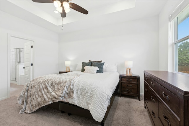 2616 Danbury Ln, Leander, TX 78641 - bedroom featuring a raised ceiling, light carpet, ceiling fan, and connected bathroom