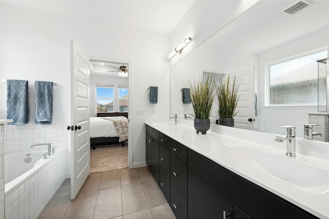 2616 Danbury Ln, Leander, TX 78641 - ensuite bathroom featuring double vanity, a garden tub, tile patterned flooring, and a ceiling fan