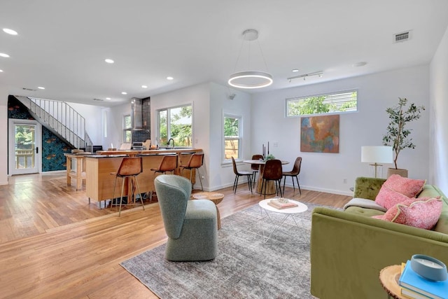 1708 Briar St, Austin, TX 78704 - living room featuring stairs, healthy amount of natural light, light wood-style floors, and recessed lighting