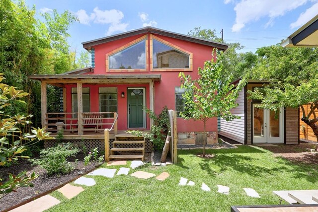 1708 Briar St, Austin, TX 78704 - view of front facade with a porch, a front lawn, french doors, and stucco siding
