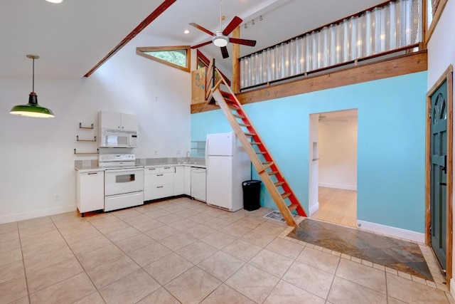 1708 Briar St, Austin, TX 78704 - kitchen with white appliances, high vaulted ceiling, ceiling fan, light countertops, and white cabinetry