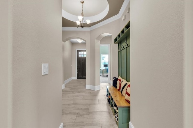 101 Dorado St, Georgetown, TX 78628 - entrance foyer featuring arched walkways, crown molding, a chandelier, light marble finish flooring, and a raised ceiling