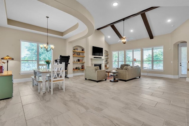 101 Dorado St, Georgetown, TX 78628 - dining room with built in shelves, ceiling fan, arched walkways, a fireplace, and healthy amount of natural light