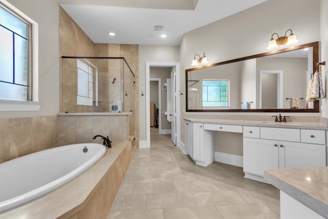 101 Dorado St, Georgetown, TX 78628 - bathroom featuring a stall shower, vanity, a garden tub, and tile patterned flooring