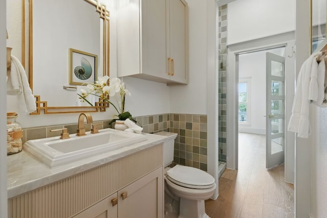 6905 Rudi Cv, Austin, TX 78759 - full bathroom with vanity, tile walls, and a shower