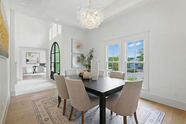 6905 Rudi Cv, Austin, TX 78759 - dining space with a chandelier, healthy amount of natural light, and light wood finished floors