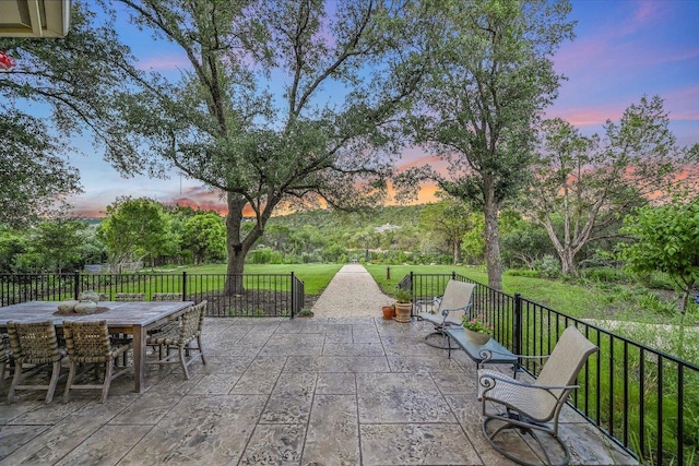 3342 Far View Dr, Austin, TX 78730 - patio terrace at dusk featuring a patio, a yard, and outdoor dining space