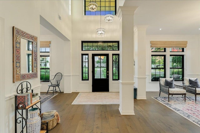 3342 Far View Dr, Austin, TX 78730 - entrance foyer with decorative columns, dark wood-type flooring, a high ceiling, and a chandelier