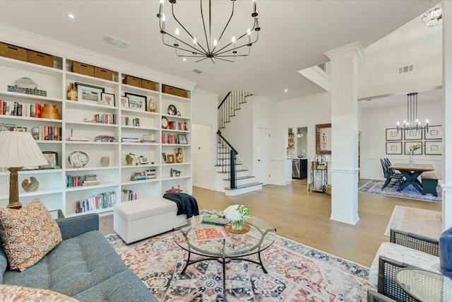 3342 Far View Dr, Austin, TX 78730 - living room with a chandelier, decorative columns, stairs, light wood-style floors, and recessed lighting