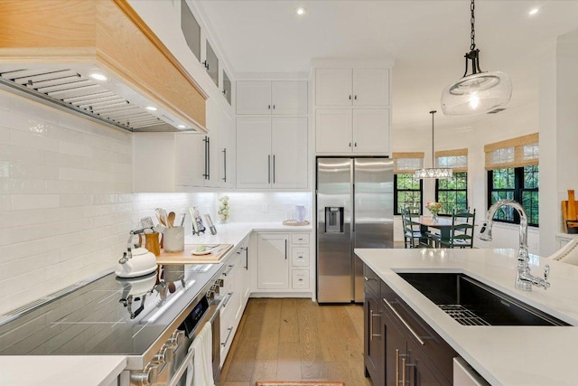 3342 Far View Dr, Austin, TX 78730 - kitchen featuring stainless steel appliances, custom range hood, white cabinetry, light wood-style floors, and recessed lighting