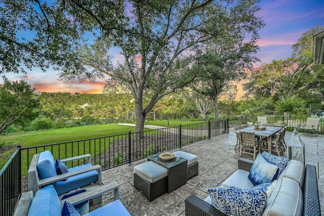 3342 Far View Dr, Austin, TX 78730 - patio terrace at dusk with outdoor lounge area, a patio area, a yard, and outdoor dining space