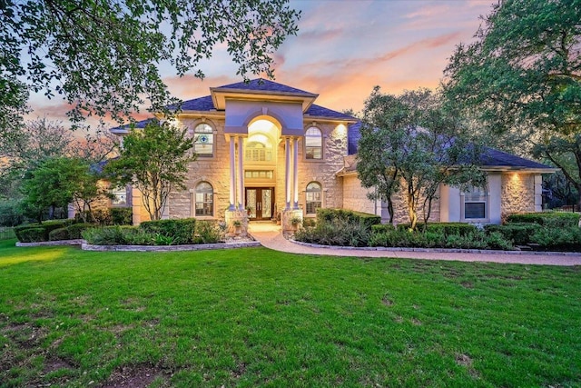 9105 Westminster Glen Ave, Austin, TX 78730 - mediterranean / spanish home featuring french doors, stone siding, and a front yard