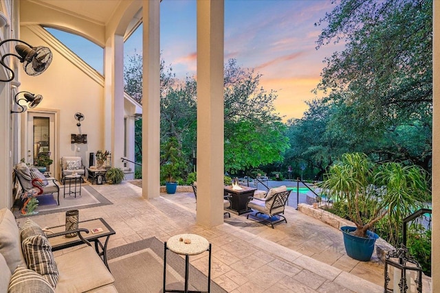 9105 Westminster Glen Ave, Austin, TX 78730 - patio terrace at dusk featuring an outdoor fire pit, an outdoor pool, and a patio area