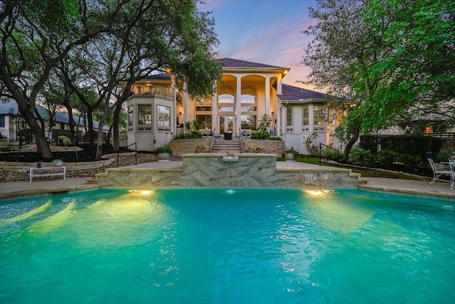 9105 Westminster Glen Ave, Austin, TX 78730 - pool at dusk with an outdoor pool and a patio area