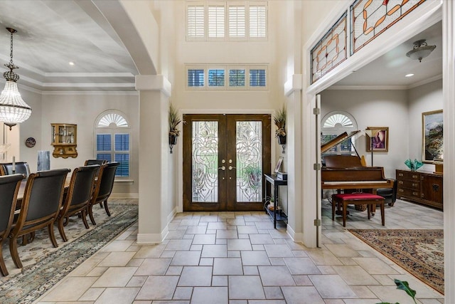 9105 Westminster Glen Ave, Austin, TX 78730 - foyer entrance with french doors, ornate columns, ornamental molding, and a towering ceiling