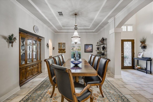 9105 Westminster Glen Ave, Austin, TX 78730 - dining space featuring a tray ceiling, stone tile floors, arched walkways, and a high ceiling