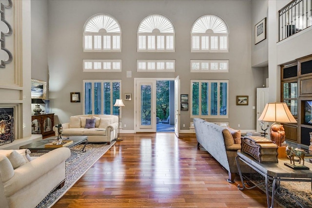 9105 Westminster Glen Ave, Austin, TX 78730 - living room featuring a towering ceiling, wood finished floors, and built in features