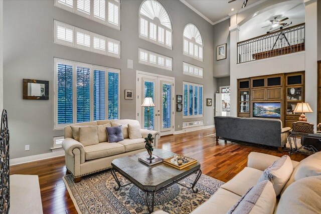 9105 Westminster Glen Ave, Austin, TX 78730 - living area with a ceiling fan, a high ceiling, wood finished floors, crown molding, and plenty of natural light