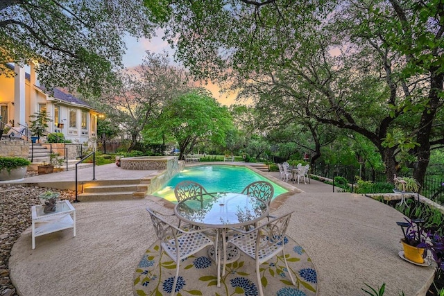 9105 Westminster Glen Ave, Austin, TX 78730 - pool at dusk featuring a patio area and an outdoor hot tub
