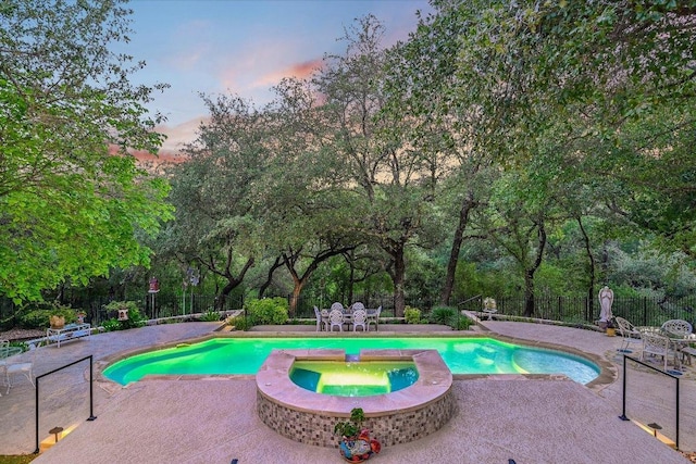 9105 Westminster Glen Ave, Austin, TX 78730 - pool at dusk with a patio, a fenced backyard, and view of wooded area