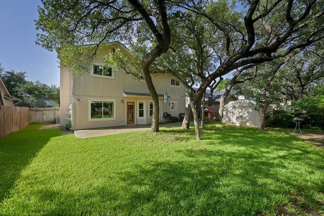 6712 Shiner St, Austin, TX 78729 - back of property with a storage unit, a patio, and a fenced backyard