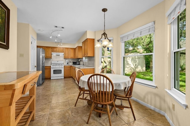 6712 Shiner St, Austin, TX 78729 - dining room with a chandelier and light tile patterned flooring