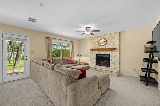 6712 Shiner St, Austin, TX 78729 - living room with carpet floors, a stone fireplace, and ceiling fan
