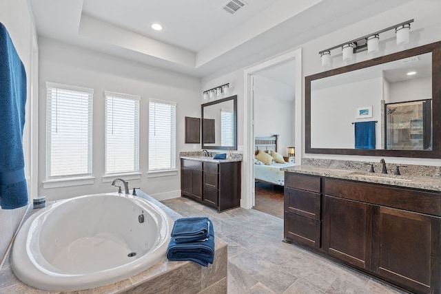 164 Mary Cornelia Cv, Buda, TX 78610 - full bathroom with a tub with jets, two vanities, healthy amount of natural light, and a shower stall