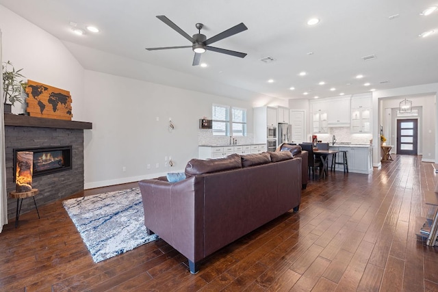 164 Mary Cornelia Cv, Buda, TX 78610 - living area with ceiling fan, dark wood finished floors, a fireplace, and recessed lighting